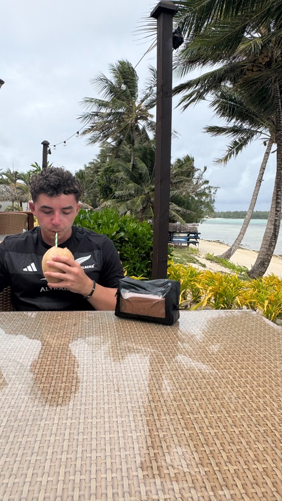 Erik at a beachside table during a tropical trip